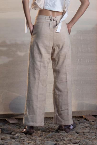 Tea dyed Eri silk pleated trousers with broad turn-up hem.